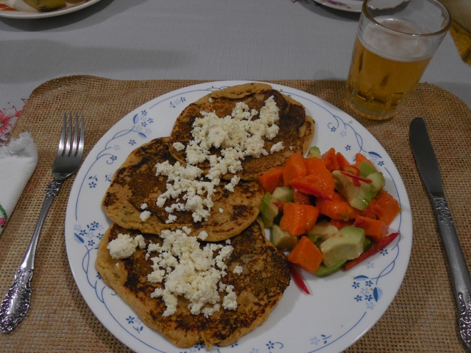 Savory cornmeal cakes with ricotta cheese crumbles. Served with a papaya-avocado-sweet red pepper salad (dressed simply with limón juice). photo © Lorraine Caputo